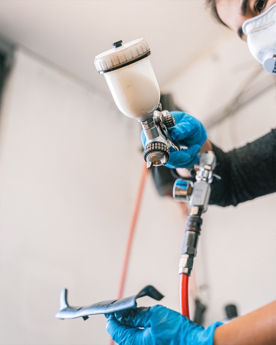 Professional paint spray gun in workshop